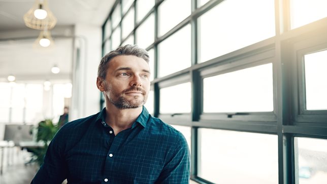 Man looking out window